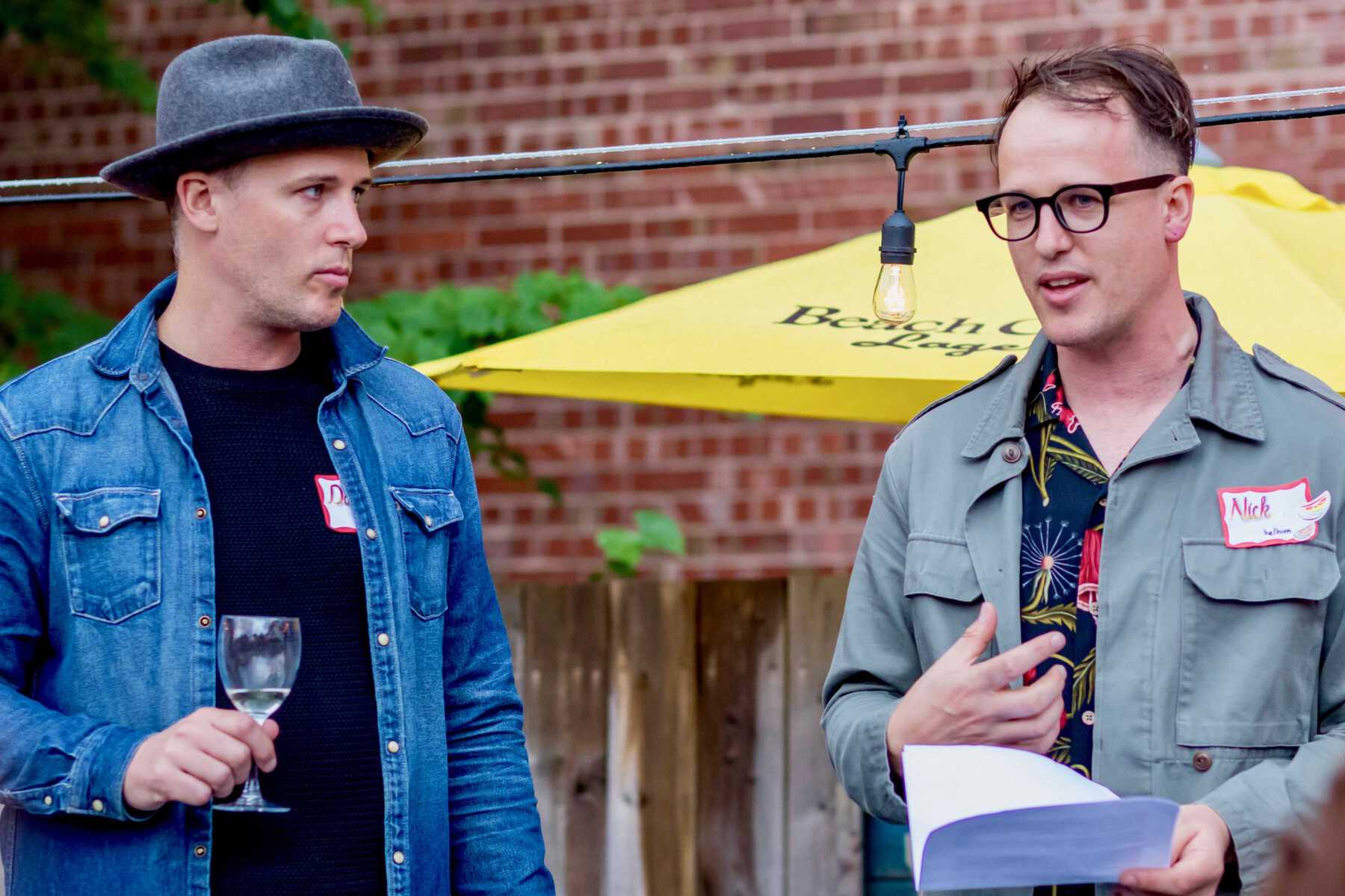 Two men speaking at microphone