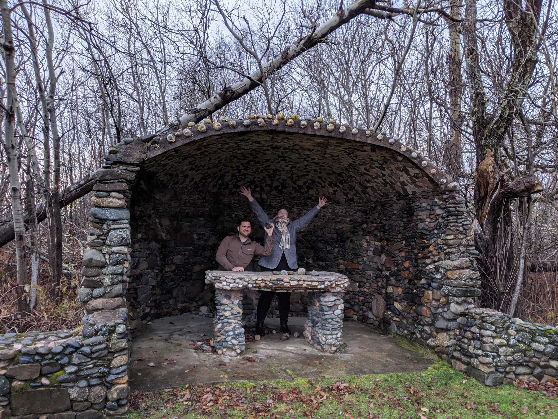 Man and woman smiling in stone structure