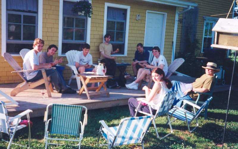 Group of people sitting on deck chairs in summer