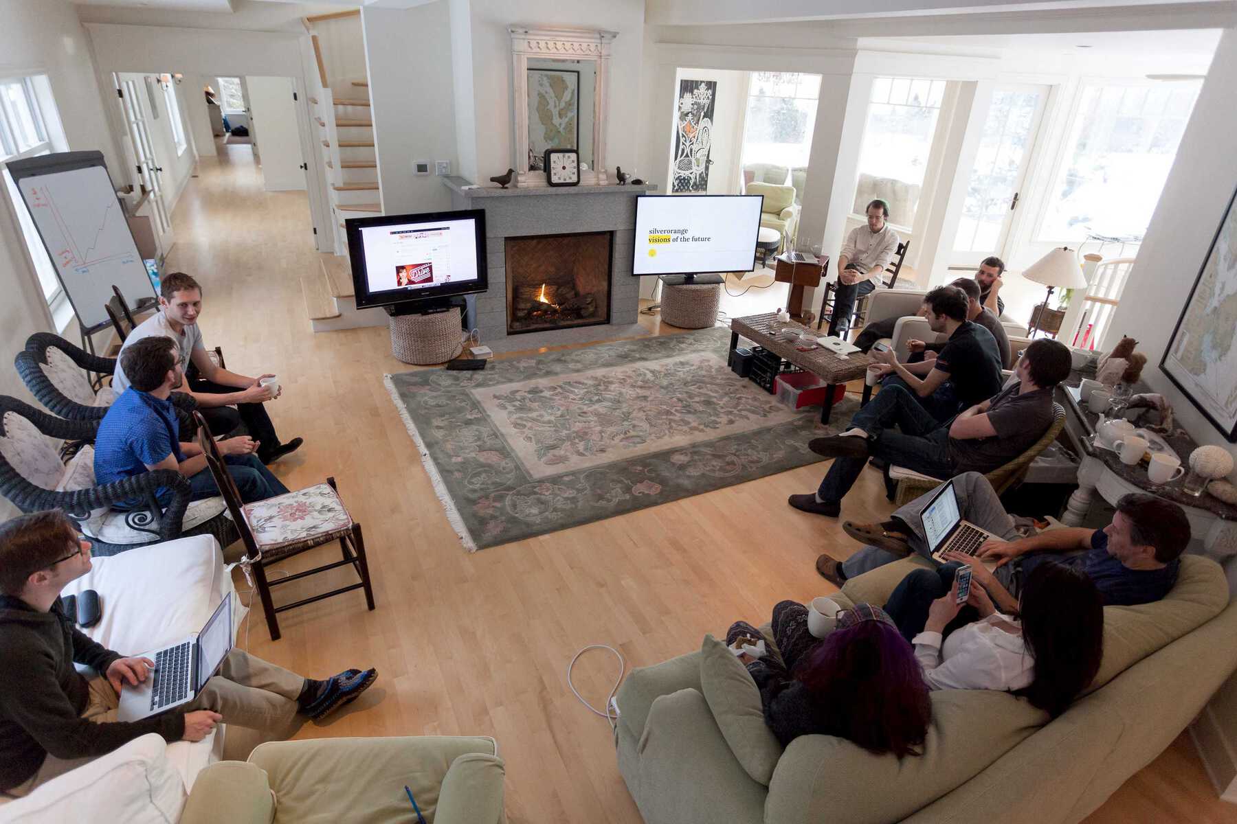 Group sitting around TVs